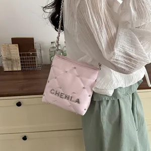 Pink quilted shoulder bag for women with chain strap, rhinestone studs and CHENLA metal letters.