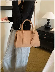 Detailed shot of retro matte texture Boston handbag, versatile casual crossbody design.