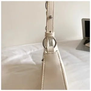 White leather shoulder bag side detail, minimalist design, stylish daily accessory.
