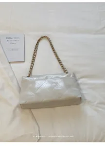 White quilted chain shoulder bag for women, elegant minimalist crossbody bag with leather strap.