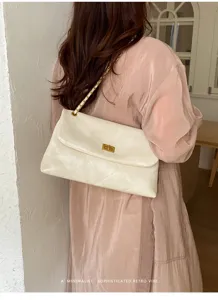 Stylish women's quilted shoulder bag with chain strap and elegant turn-lock closure.