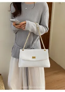 White quilted shoulder bag detail, stylish gold chain strap and chic turn-lock closure style.