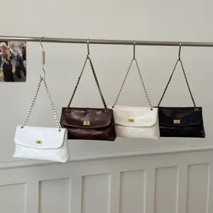 Women's stylish quilted leather shoulder bag with metal chain strap and turn-lock closure.