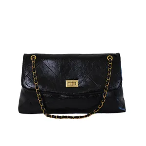 Stylish black quilted leather shoulder bag for women with luxury gold chain and metal turn lock.