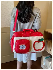 Spacious travel duffel bag with cute apple and star pattern, casual shoulder weekender.