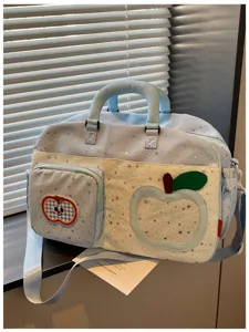 Casual star patterned travel duffel bag with cute apple patch and adjustable shoulder strap.