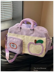 Detail view of the cute purple star print travel duffel bag with apple pockets and crossbody strap.