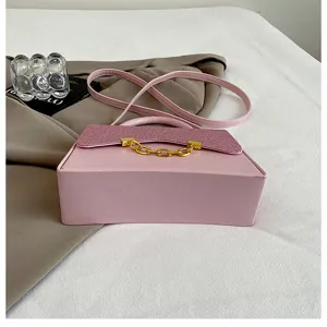 Detail view of the pink glitter flap crossbody bag showcasing the chic chain decoration.