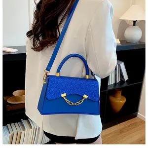 Blue glitter flap crossbody bag, stylish women's shoulder bag with chic gold chain detail.