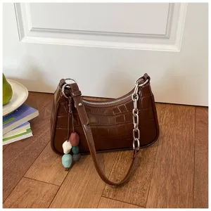Brown crocodile pattern PU leather underarm shoulder bag with chain and stone charm detail.
