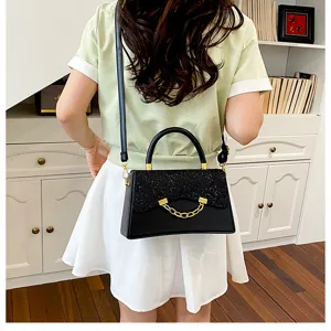 Stylish black square shoulder bag with glitter flap and chic gold chain detail for women.