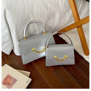 Silver glitter square handbag set with gold chain detail, elegant chic design for women.