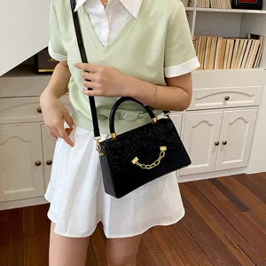 Stylish black small square bag for women, featuring a glitter flap and chic gold chain detail.