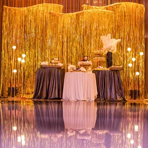 Gold foil fringe curtain backdrop for party decoration, ideal for birthdays and celebrations.