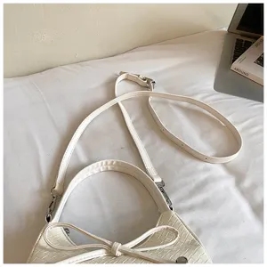 White woven shoulder bag with bow detail, stylish casual crescent cross body purse for women.