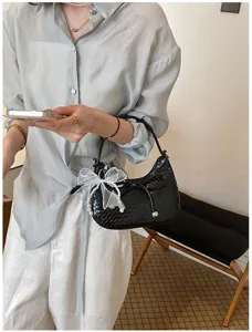 Black woven hobo shoulder bag for women, chic crescent underarm purse with pearl bow.