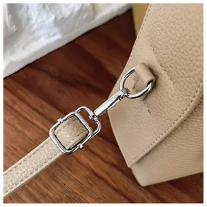 Detailed view of the women's crossbody bag featuring adjustable leather strap and metal hardware.