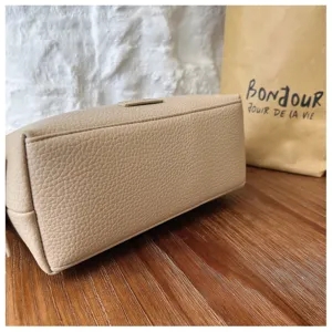 Classic solid color pebble leather cosmetic bag, minimalist portable small handbag for daily use.