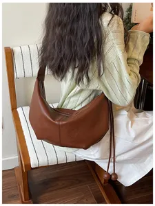 Korean style brown crescent hobo shoulder bag detail showcasing minimalist chic design.