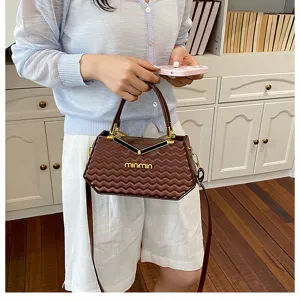 Vista dettagliata della borsa a mano marrone di tendenza con tracolla elegante.