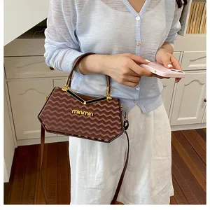 Vista dettagliata di una elegante borsa marrone con motivo ondulato, perfetta per ogni look.