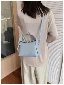 Casual blue crossbody bag for women, stylish leather shoulder bag with top handle.