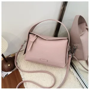 Stylish pink shoulder bag for women, premium leather crossbody bag with top handle and strap.