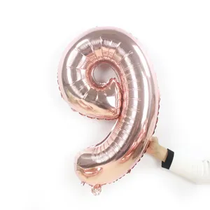 Rose gold number 9 foil balloon for birthday party decorations and celebrations. Detail view.