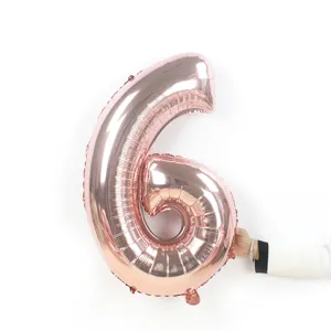 Close-up detail of the rose gold number 6 foil balloon, showing metallic texture for party.