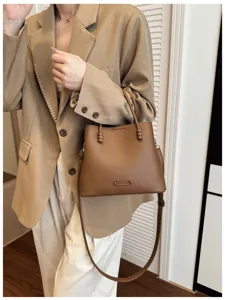 Stylish brown leather bucket bag for women, perfect for daily commuting and casual wear.