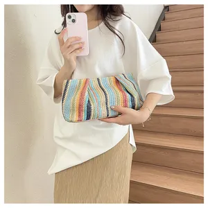 Detail view of a colorful rainbow straw woven clutch bag, perfect for summer beach style.