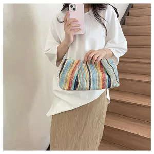Colorful striped straw clutch bag for women, stylish dumpling pouch for summer beach vacation.