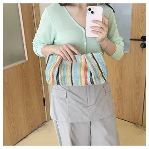 Colorful striped straw clutch bag for women, perfect for summer beach and casual seaside vacation.