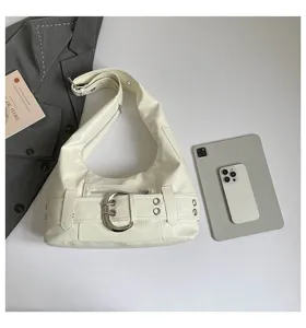 White faux leather hobo shoulder bag with large metal buckle, vintage motorcycle style detail.