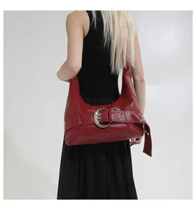 Red PU leather motorcycle shoulder bag with large metal buckle detail for women.