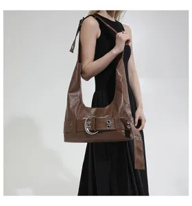 Brown retro leather shoulder bag detail, motorcycle style hobo tote with metal buckle accent.
