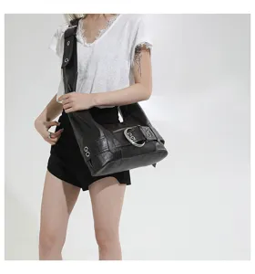 Black leather shoulder bag for women, retro motorcycle style hobo purse with large metal buckle.