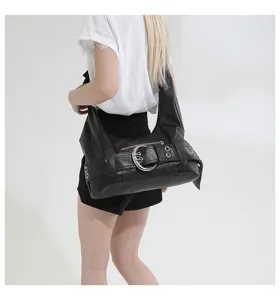 Detailed shot of a black vintage hobo shoulder bag with punk metal buckle and large capacity.