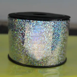Detailed view of silver holographic ribbon roll, shiny decorative balloon string for party gifts.