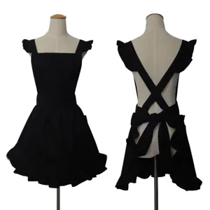 Detailed view of black ruffle apron with cross back straps, elegant workwear for cafe and salon.