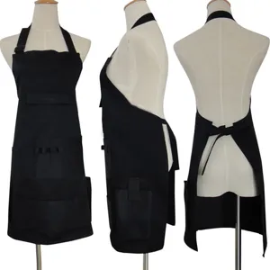 Black multi-pocket work apron with halter neck, front pockets, ideal for cafe staff.