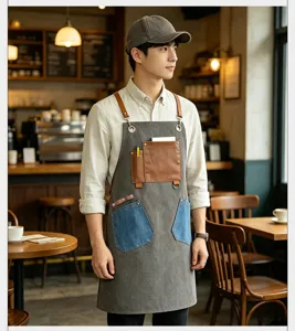 Vintage canvas work apron with leather pockets and metal rings for baristas and hairdressers.