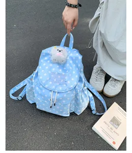 Blue polka dot backpack with cute plush puppy pendant, casual style daily school bag detail view.