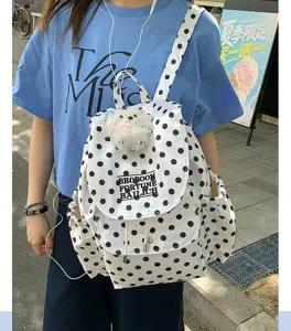 Chic polka dot casual backpack with cute puppy pendant, stylish daily daypack for women.