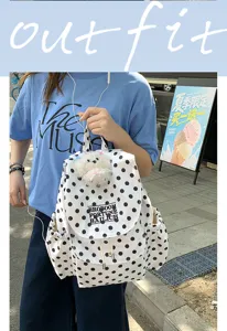 Casual white and black polka dot backpack with front flap pocket, stylish daily school bag for women