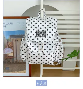 Chic polka dot backpack for women, stylish casual canvas daypack with drawstring design.