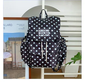 Black and white polka dot backpack, stylish casual design, daily travel shoulder bag.