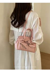 Pink shoulder handbag with top handle and stylish zipper pocket for women everyday fashion look