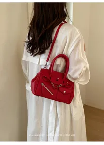 Red leather top handle shoulder bag with unique zipper design for women stylish daily commuting