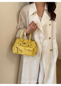 Korean style yellow leather handbag with metal lock and front zipper pockets for women.